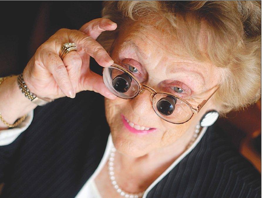 senior woman with macular degeneration, using bioptic telescopes