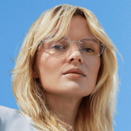 blond woman wearing rimless silhouette eyeglasses.png