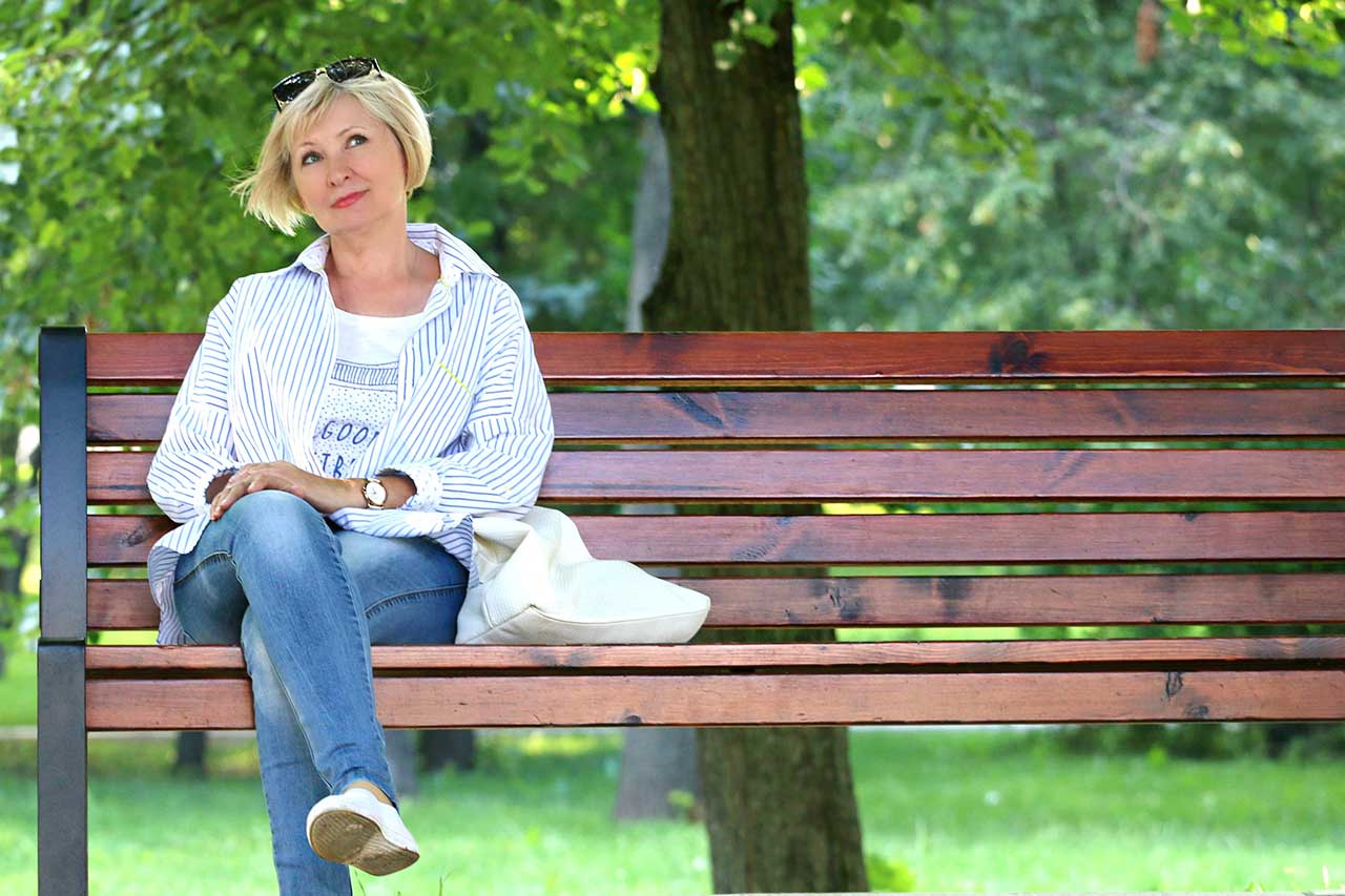 Woman sitting on bench, wearing scleral contact lenses